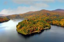 Vermont lake with a fall mountain range in the background.