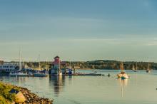 Boat marina with sailboats at sunset.