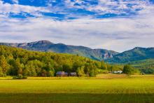 Farm landscape with Mt. Mansfield in the background in Stowe, Vermont.